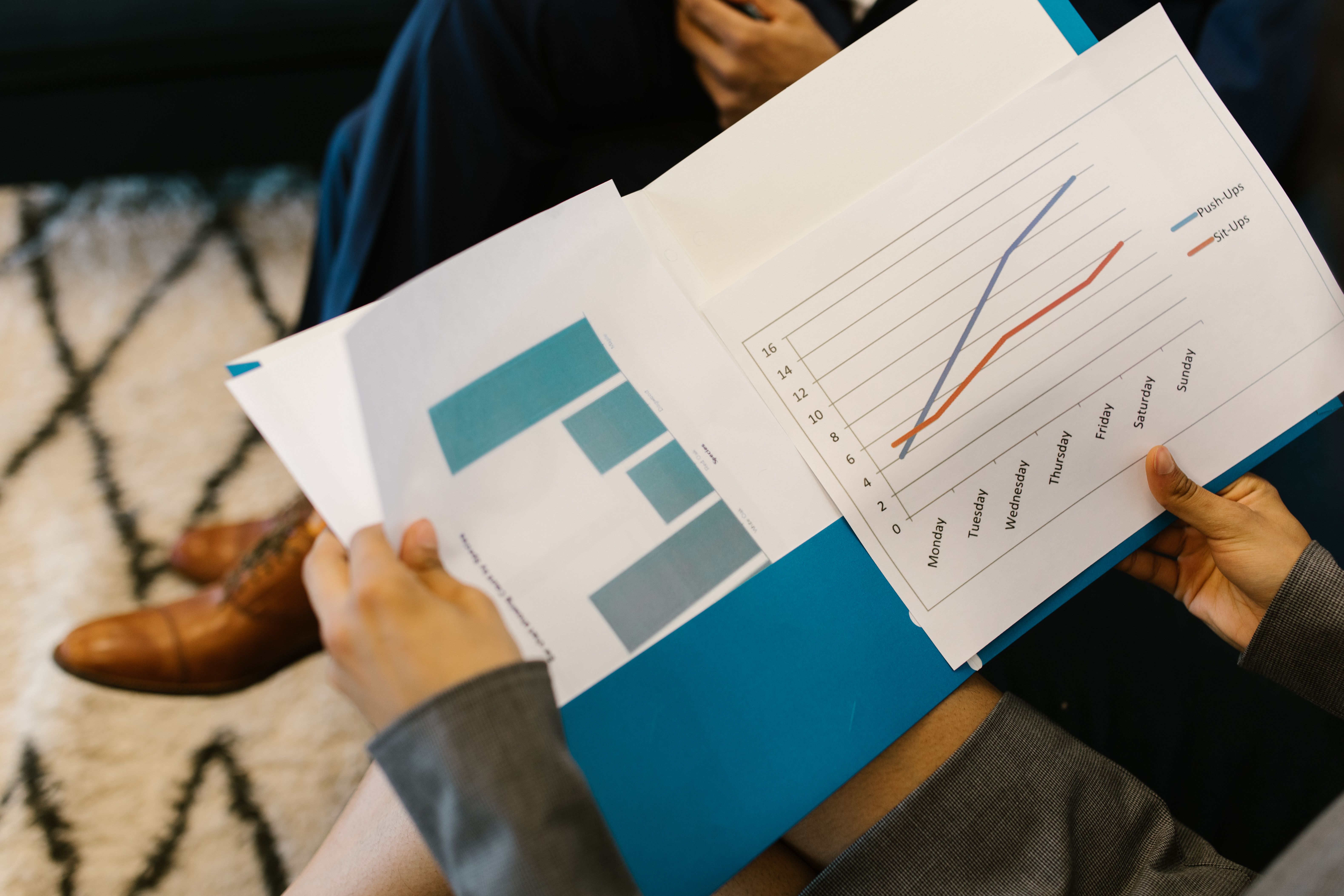 Detailed view of business reports with graphs during a corporate meeting for spotting financial red flags