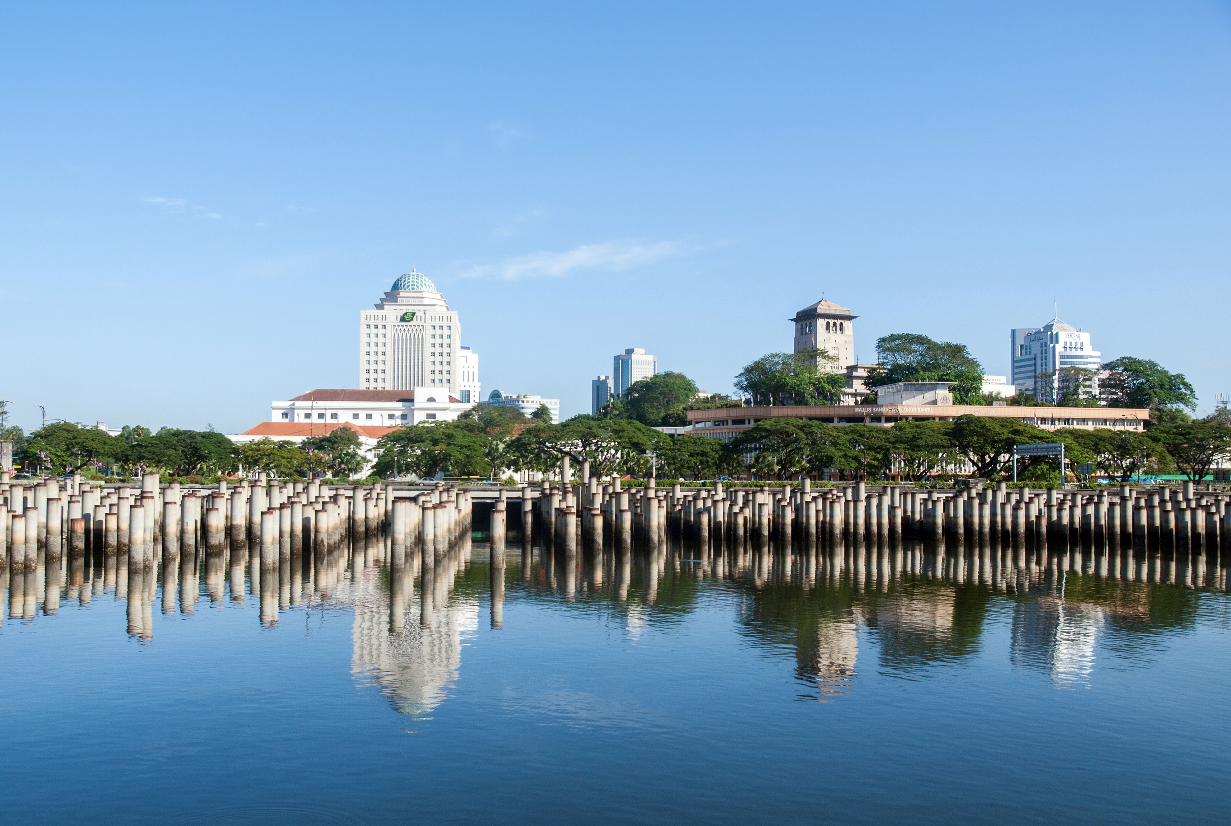 Johor Bahru skyline reflecting on calm water, the starting point of the coalition collapse