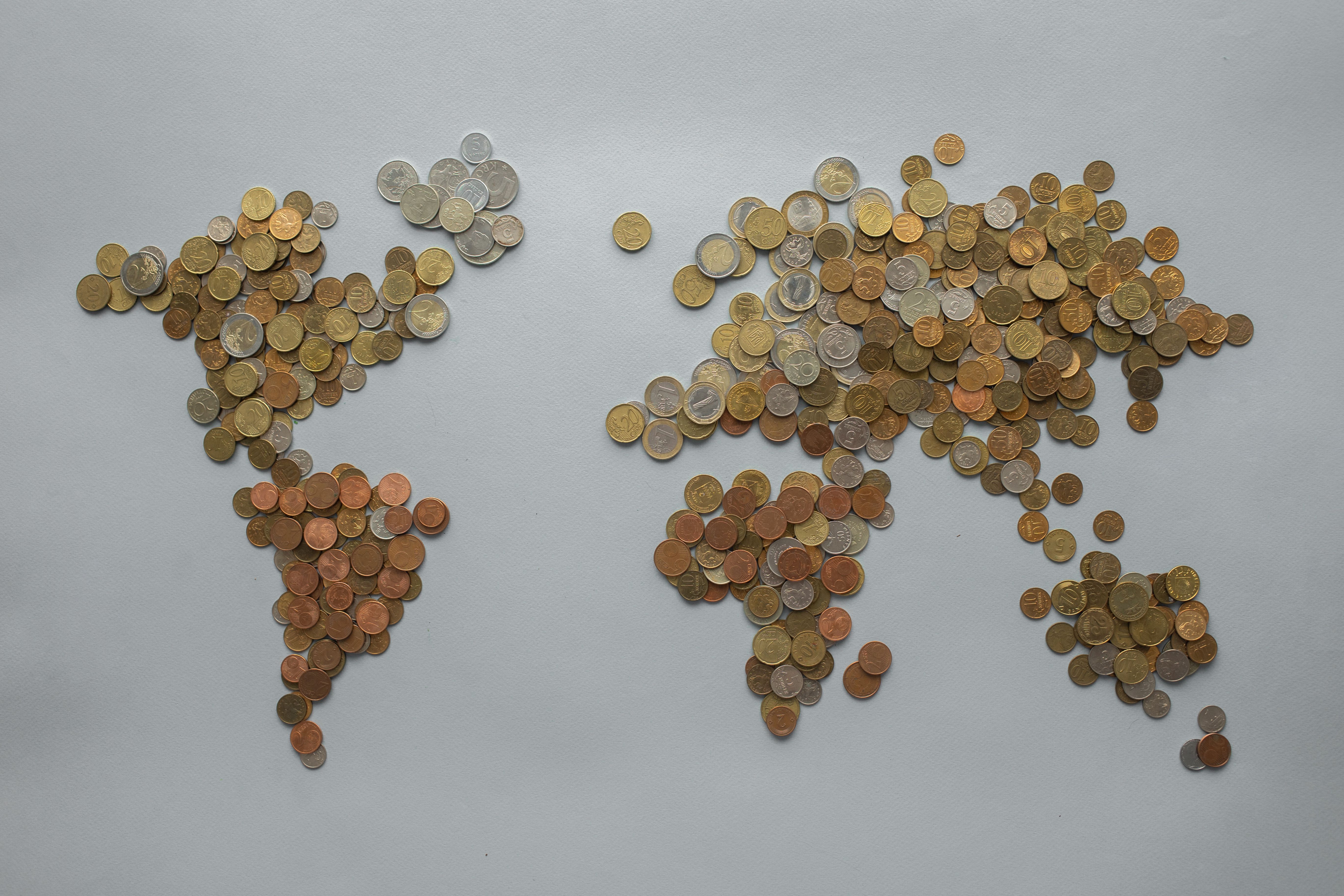 World map made from assorted coins symbolizing global finance and economic policy