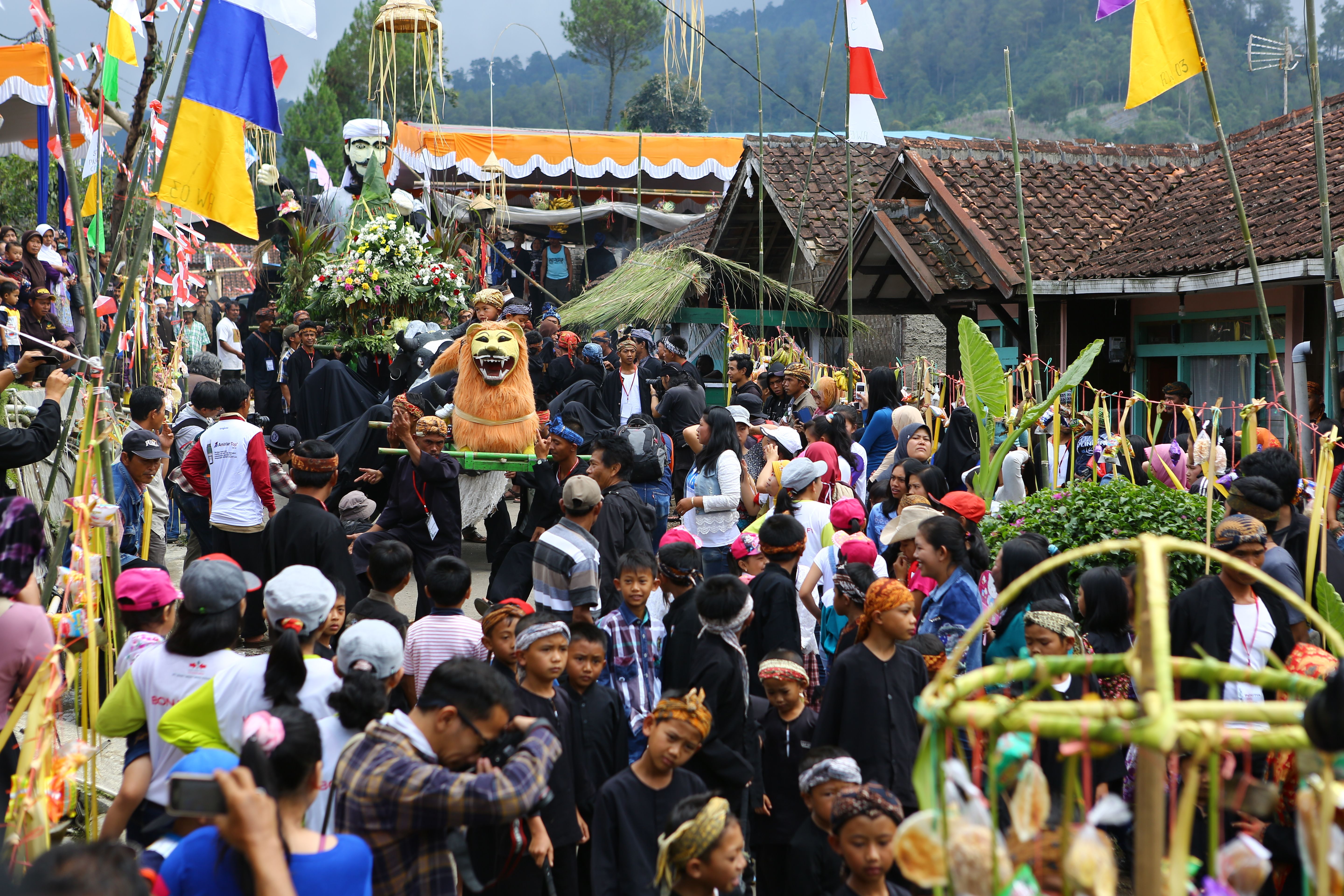 Crowds gather for a traditional cultural festival in Lembang, Indonesia, in vibrant costumes
