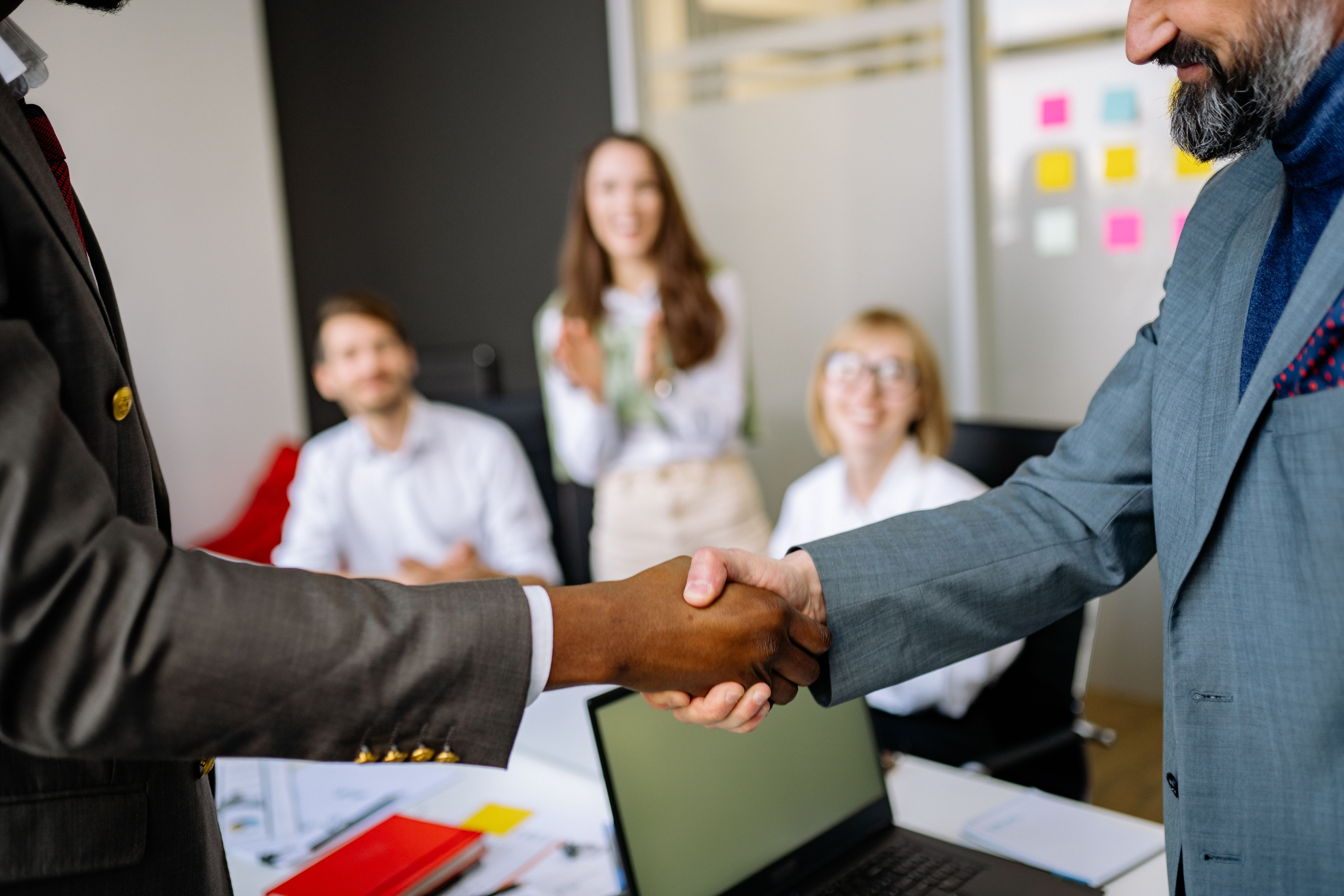 Close-up of colleagues shaking hands in a professional office setting