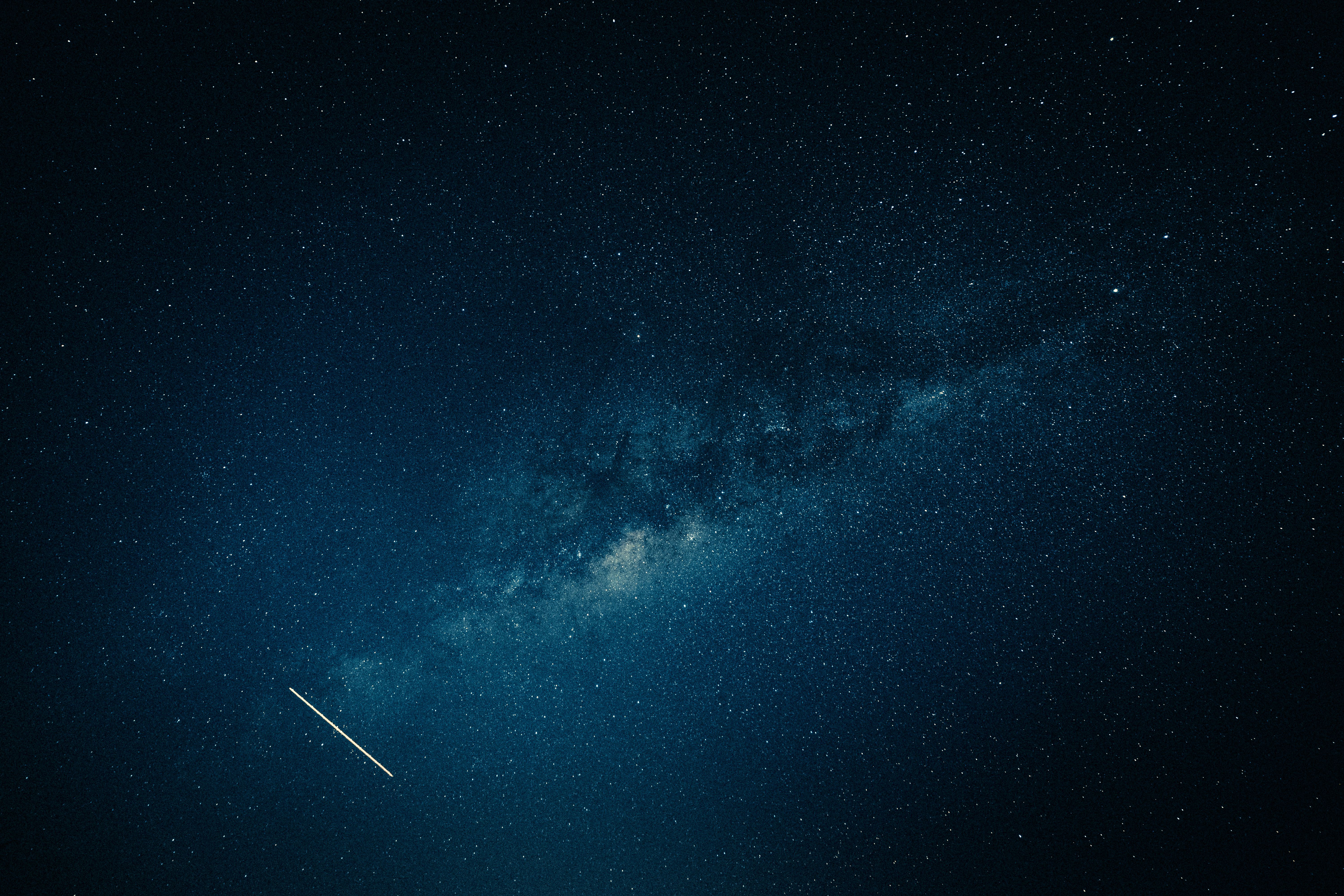 Milky Way and shooting star glowing across a clear night sky, suggesting cosmic connection.