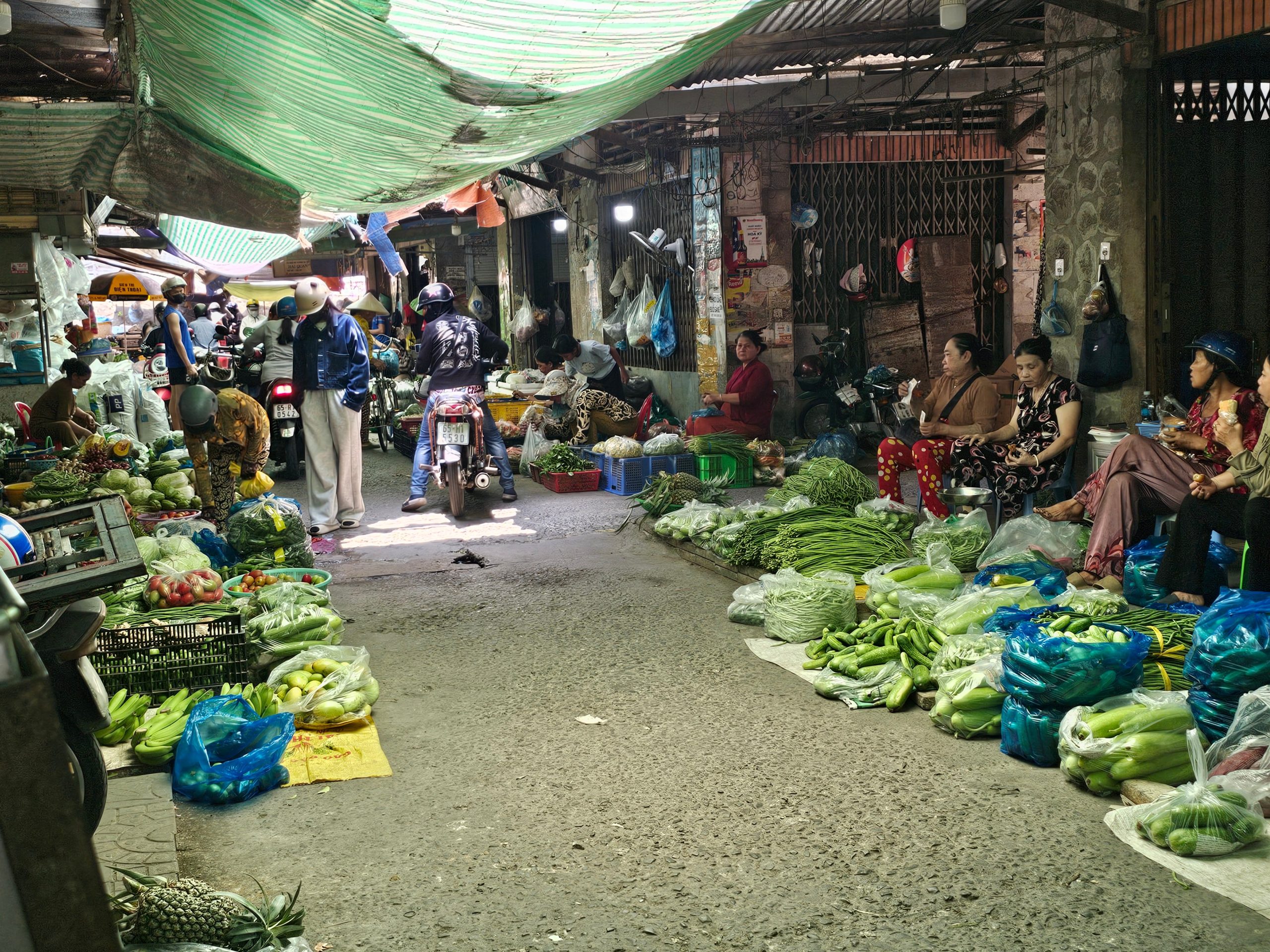 Vibrant indoor market scene in Vietnam with fresh vegetables and local vendors